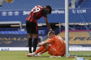 Aaron Ramsdale comforted by teammate Philip Billing following Bournemouth's relegation