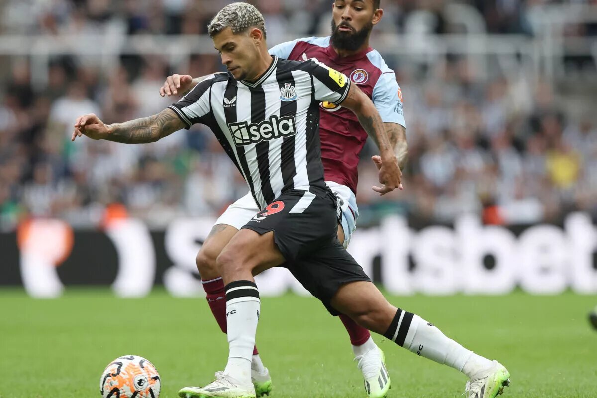 Newcastle United's Bruno Guimaraes battles for the ball with Aston Villa's Douglas Luiz.
