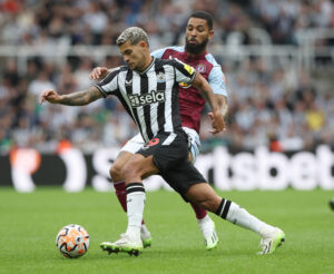Newcastle United's Bruno Guimaraes battles for the ball with Aston Villa's Douglas Luiz.
