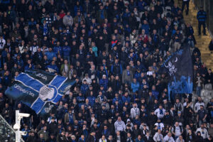 Atalanta fans waving a flag in support of their team