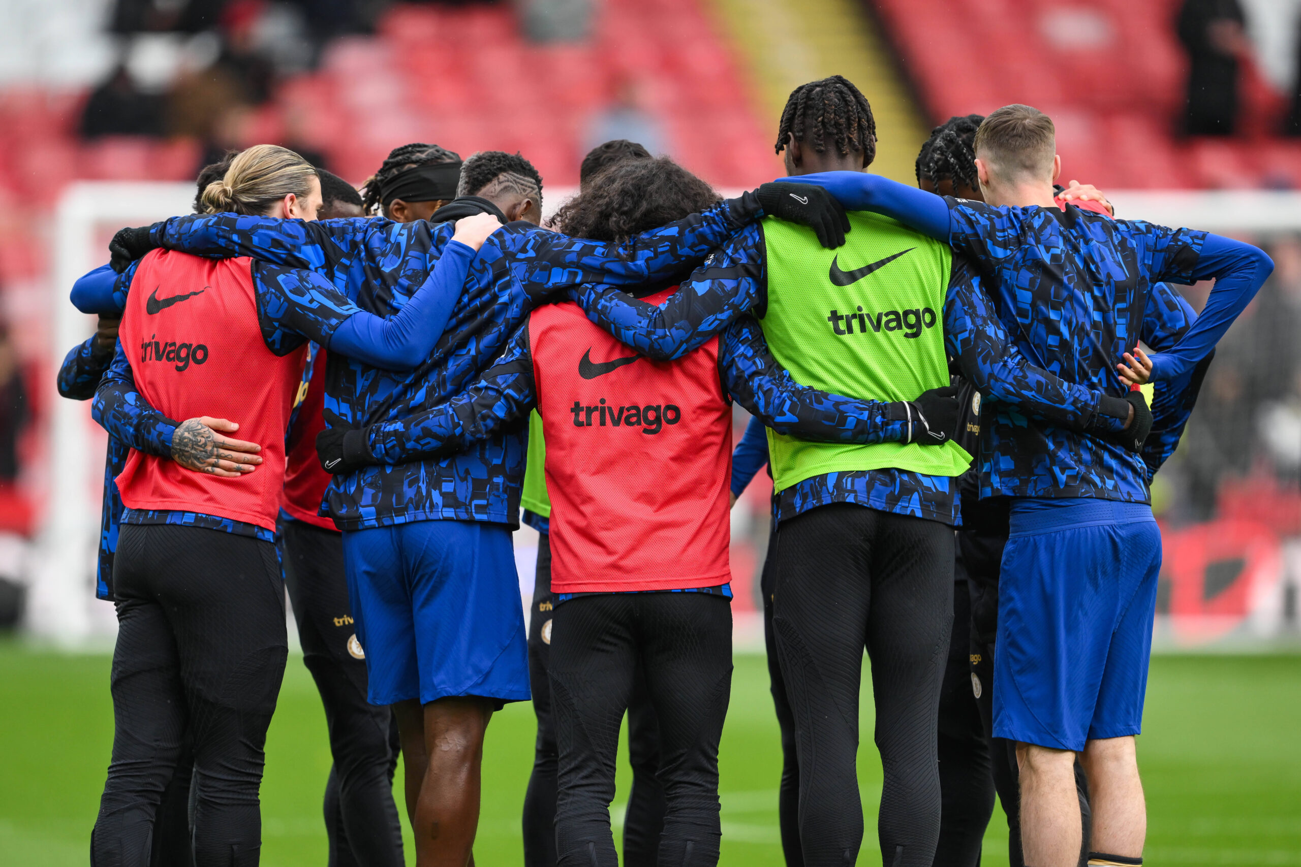 Chelsea players huddle in training gear for pre-match talk