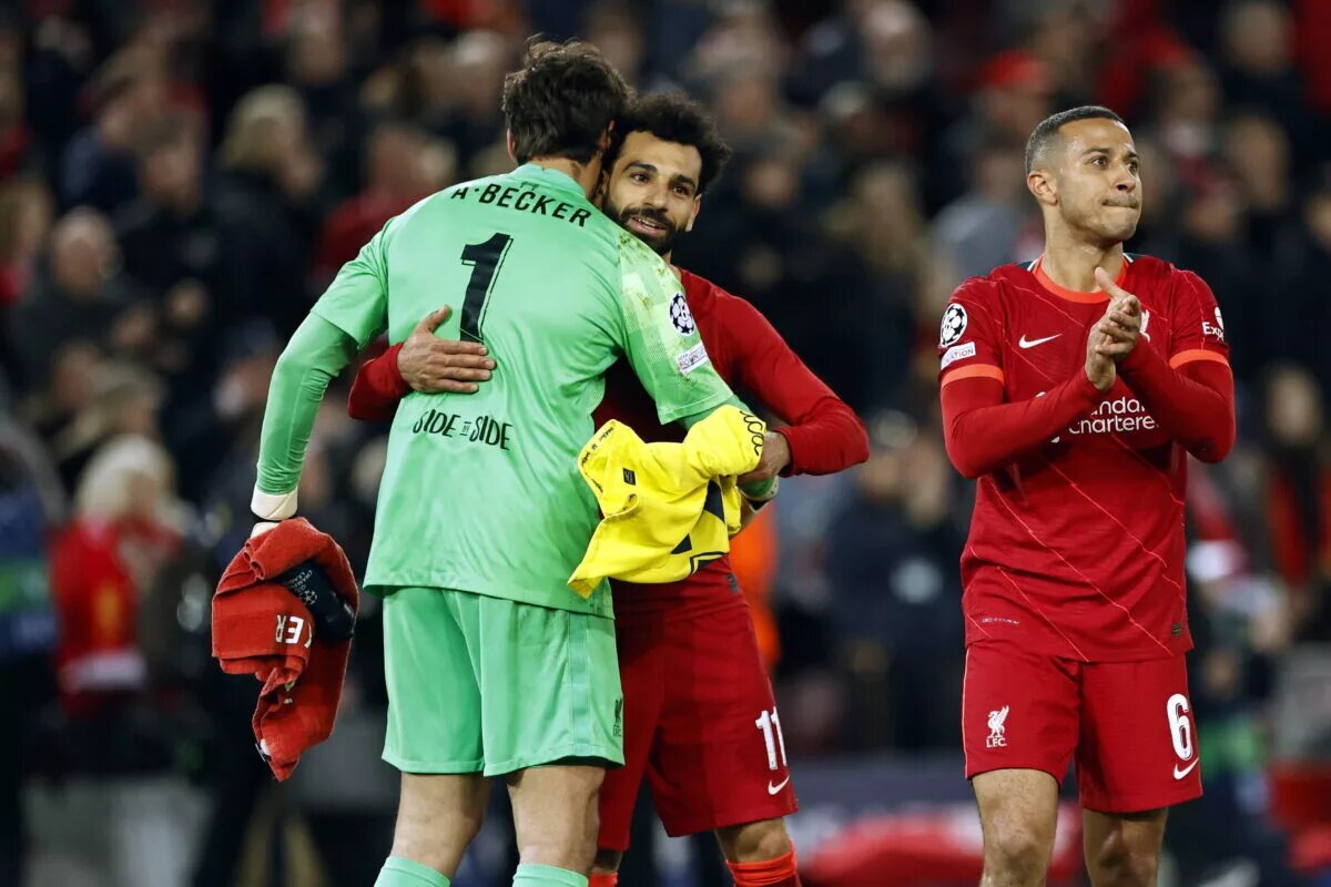 Mohamed Salah and Alisson embrace following a match