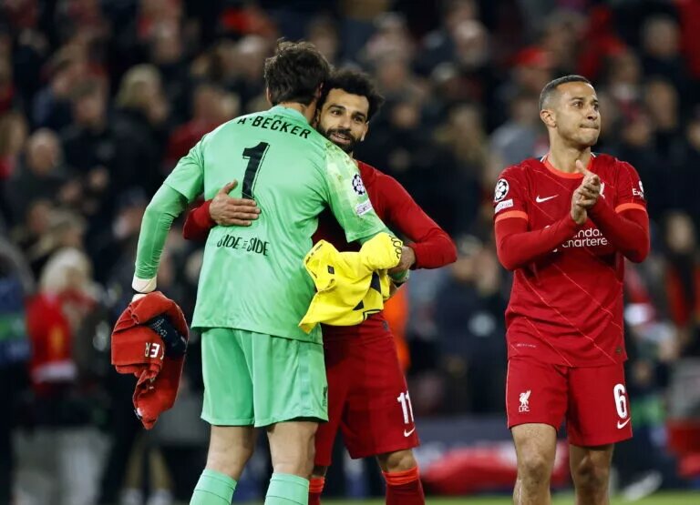 Mohamed Salah and Alisson embrace following a match