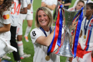 Sonia Bompastor pictured holding the Women's Champions League trophy