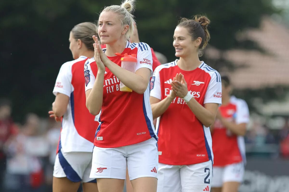 Leah Williamson and Emily Fox applaud the fans as they leave the pitch