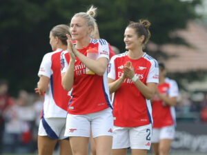 Leah Williamson and Emily Fox applaud the fans as they leave the pitch