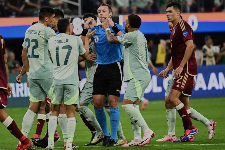 Mexican players swarm the referee
