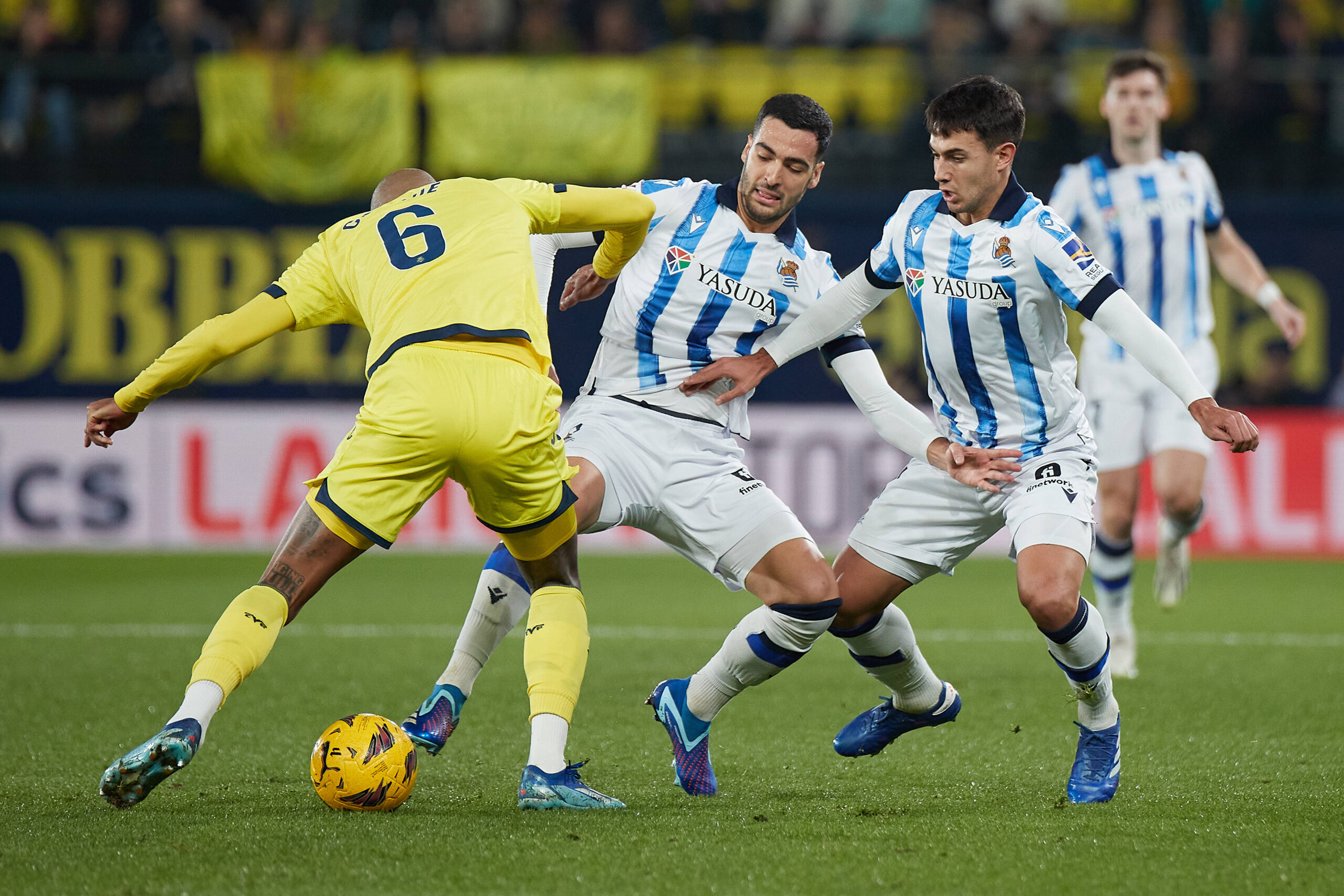 Real Sociedad's Mikel Merino and Martin Zubimendi fighting for the ball with Villarreal's Etienne Capoue.