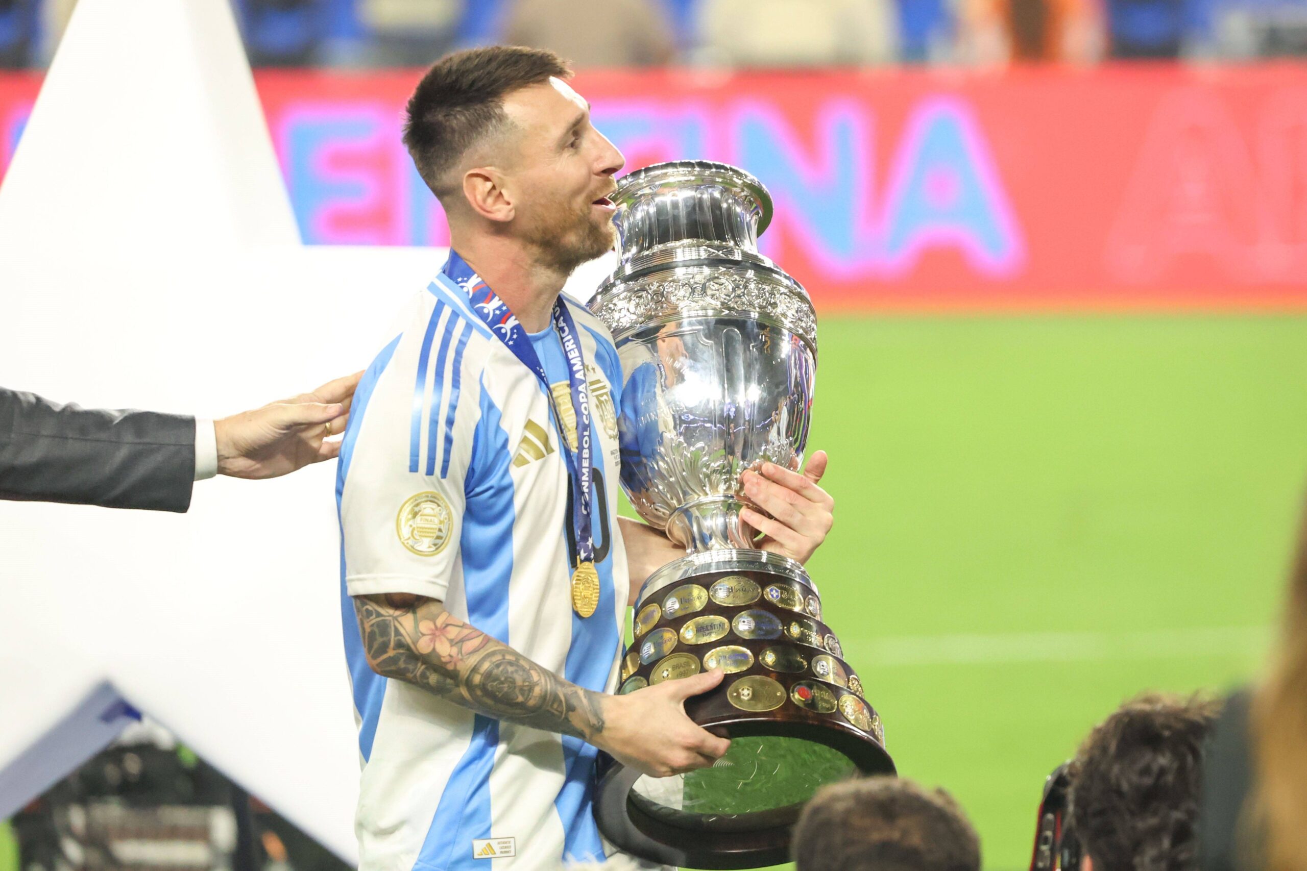 Lionel Messi holding the 2024 Copa America trophy