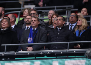 Behdad Eghbali and Todd Boehly watch on from the stands during the Carabao Cup final