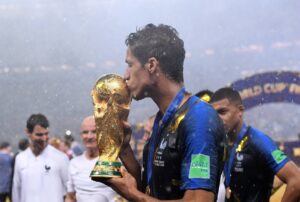 Raphael Varane kisses 2018 World Cup trophy