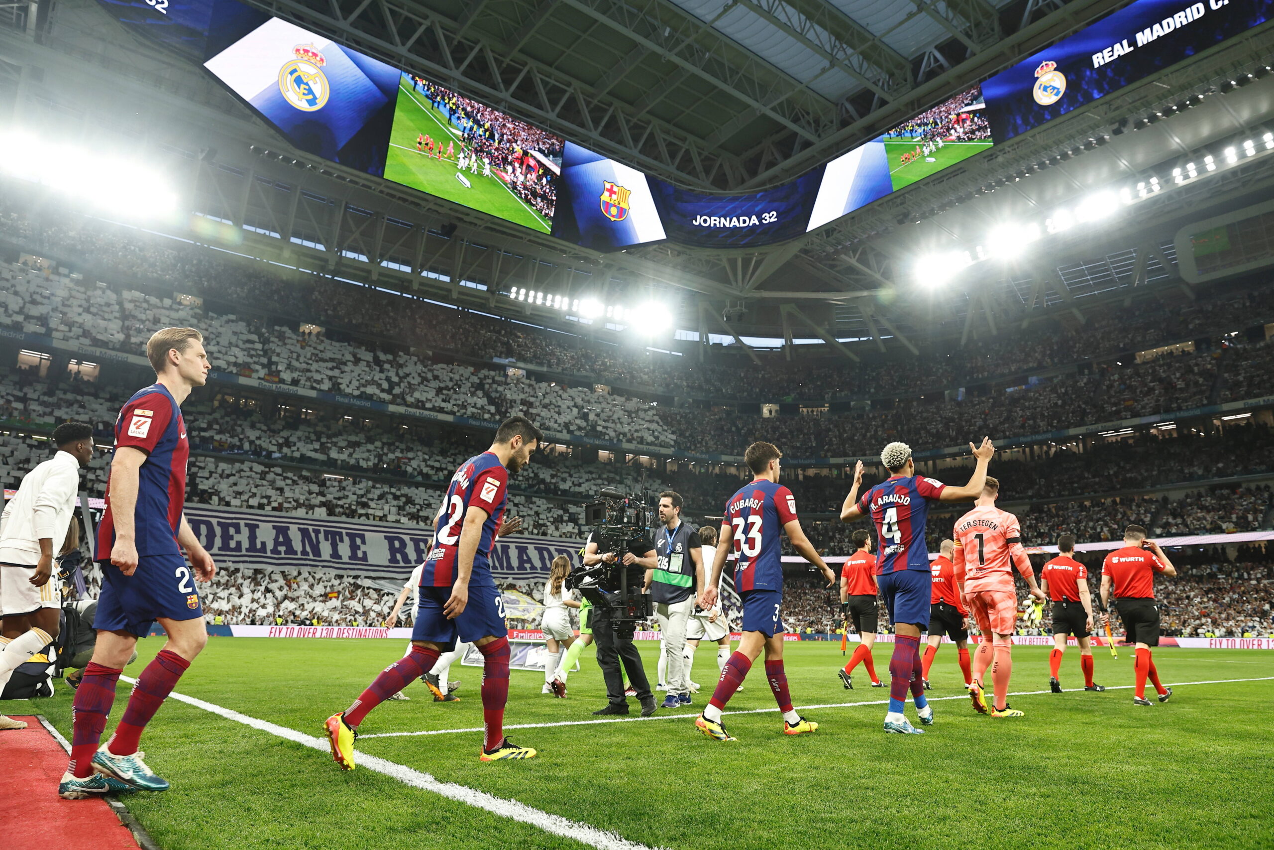 Real Madrid and Barcelona teams enter the pitch for El Clasico