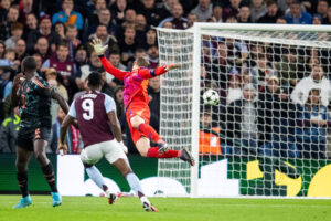 Jhon Duran chips the ball over Manuel Neuer