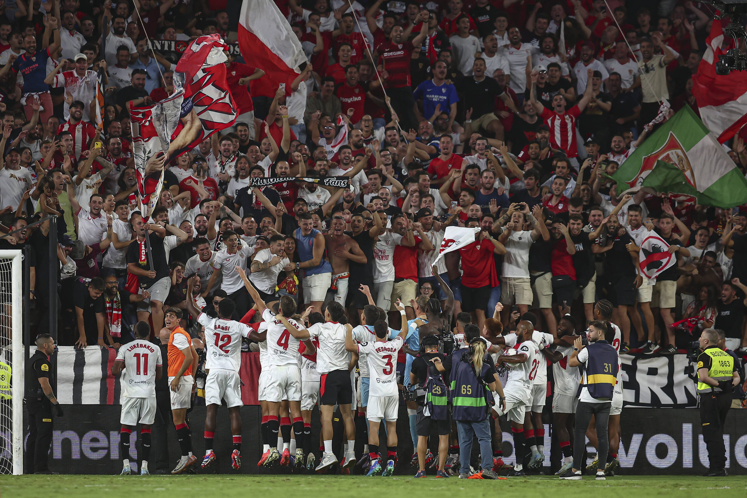 Sevilla FC Players celebrate with the fans after victory over Real Betis