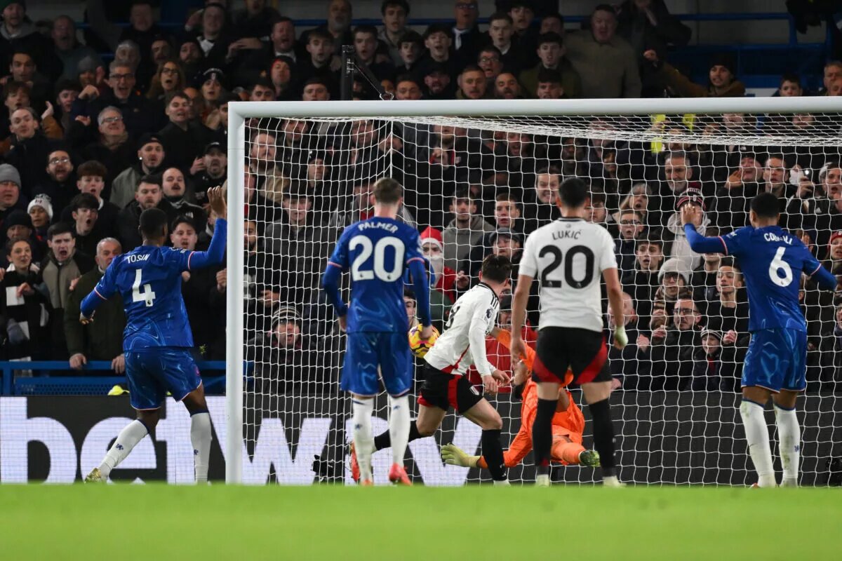 Chelsea players watch as Fulham score