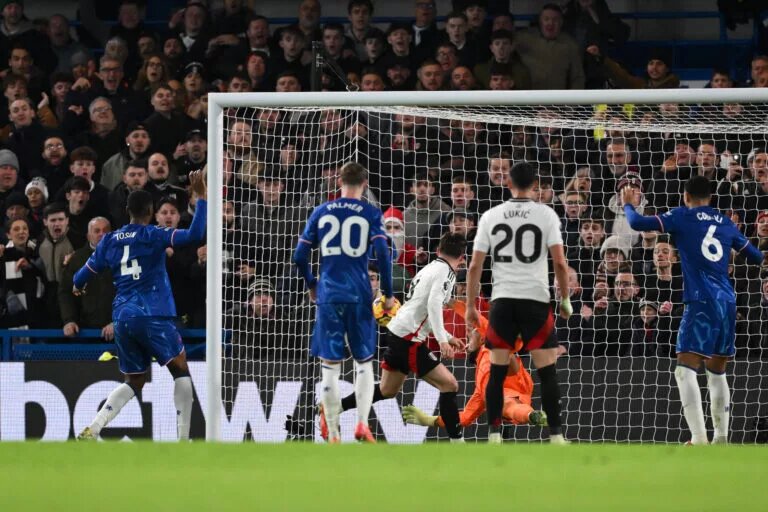 Chelsea players watch as Fulham score