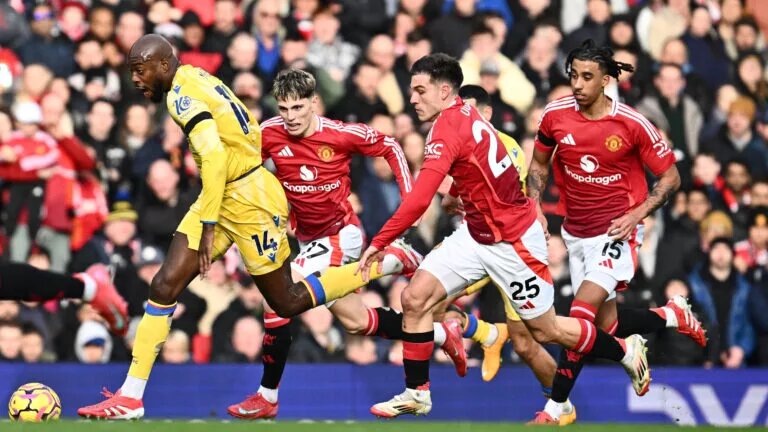 Manchester United players chase an opposition attacker