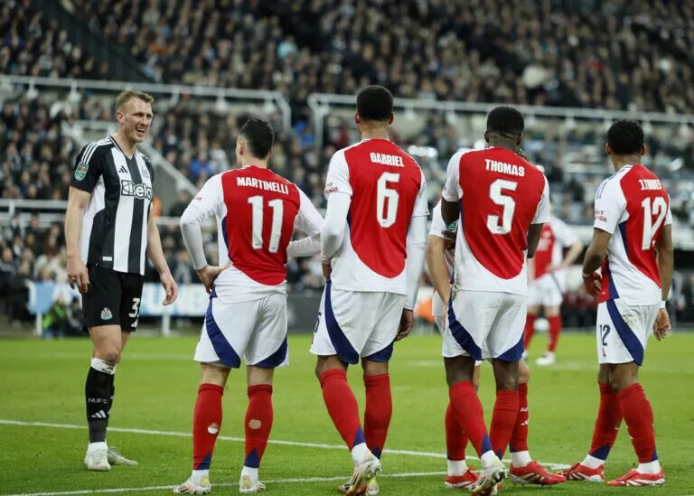 Dan Burn laughs with Arsenal's Gabriel Martinelli, Gabriel, Thomas Partey and Jurrien Timber