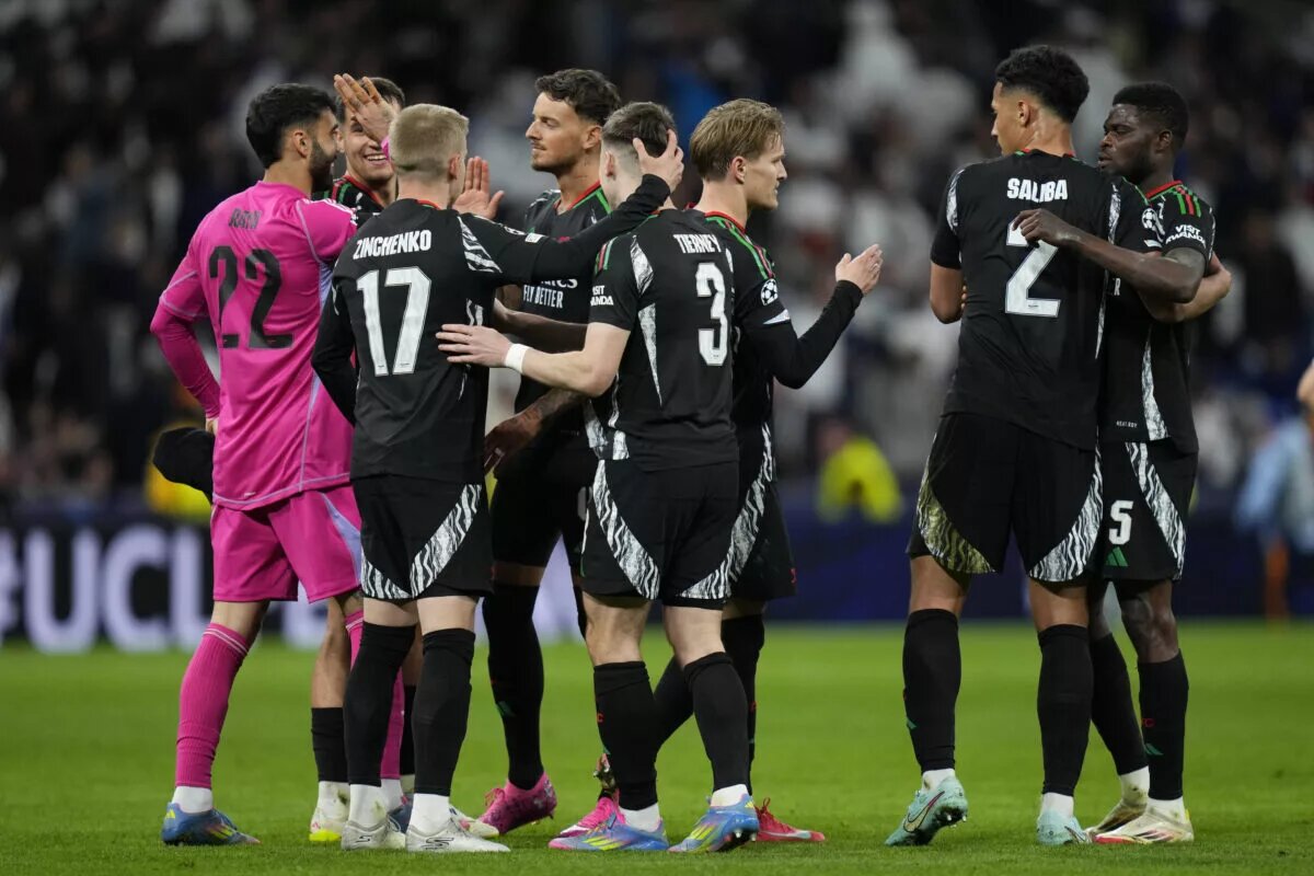 Arsenal team celebrate after Real Madrid victory