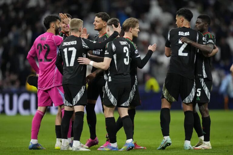 Arsenal team celebrate after Real Madrid victory