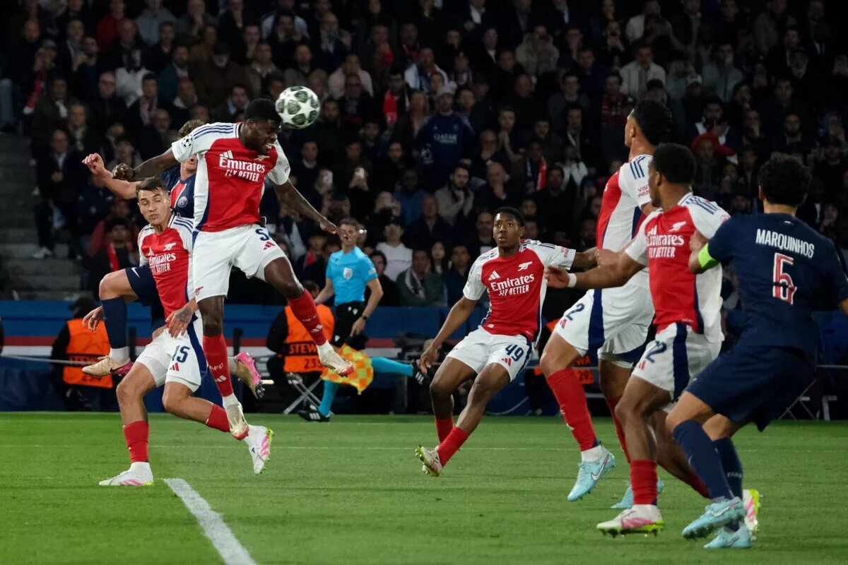 Thomas Partey heads ball to clear against Paris Saint-Germain