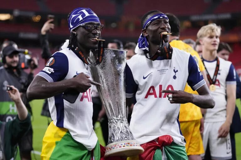 Yves Bissouma and Pape Matar Sarr celebrate holding the Europa League Trophy