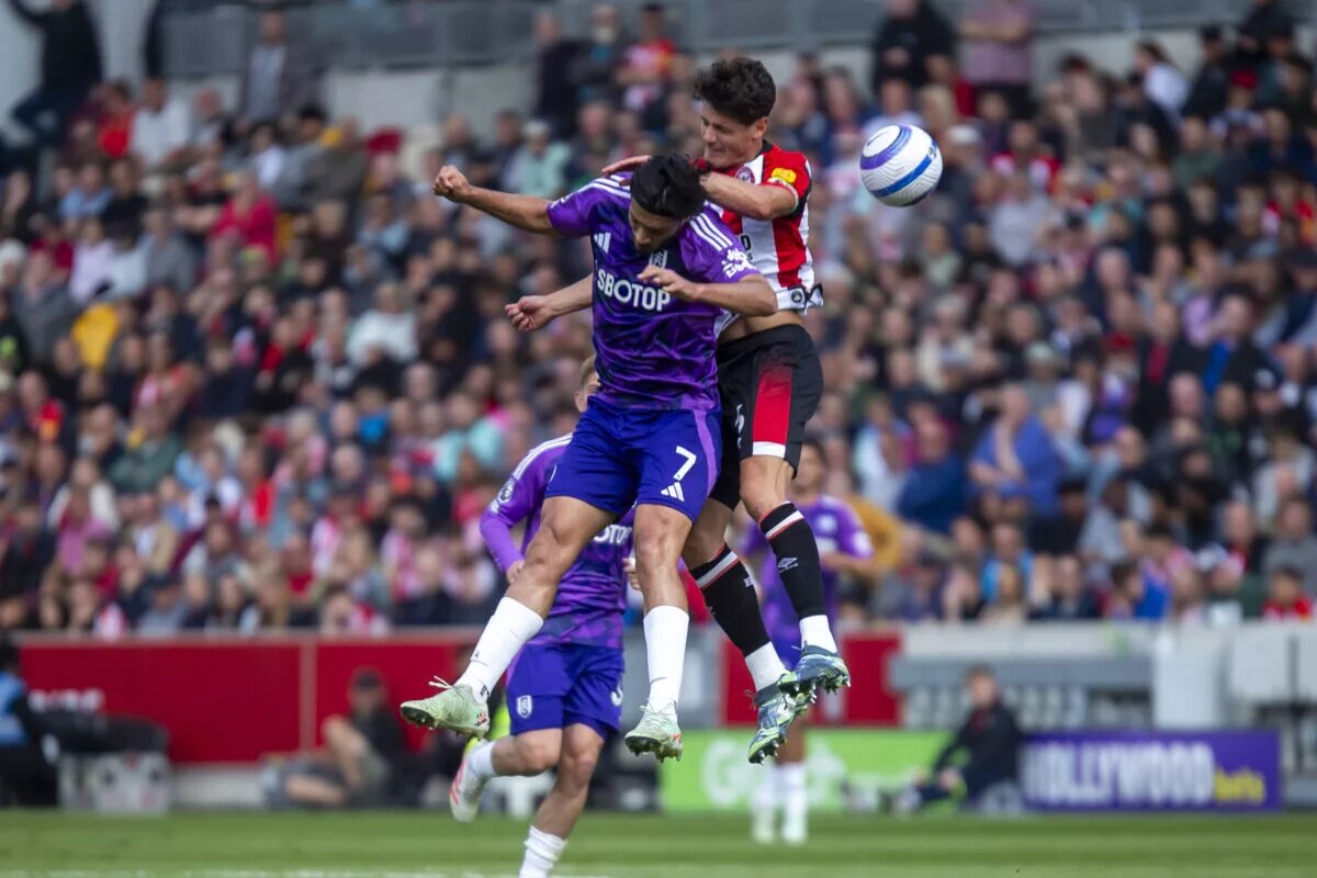 Christian Norgaard competes with Raul Jimenez for a header