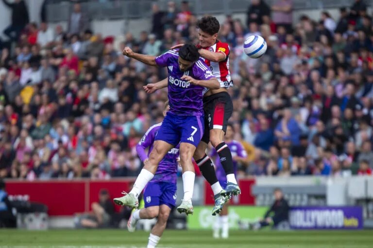 Christian Norgaard competes with Raul Jimenez for a header