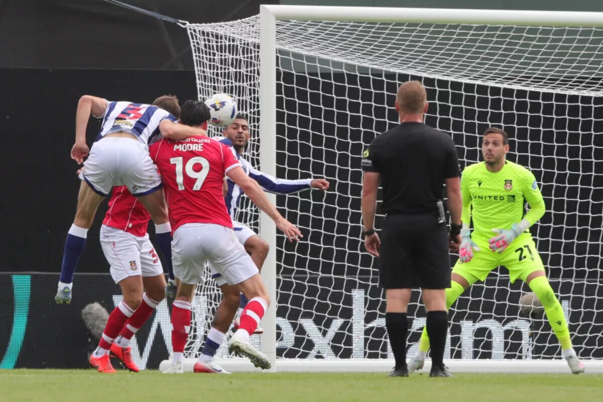 Wrexham Team News vs Portsmouth - image of Kieffer Moore battling for possession