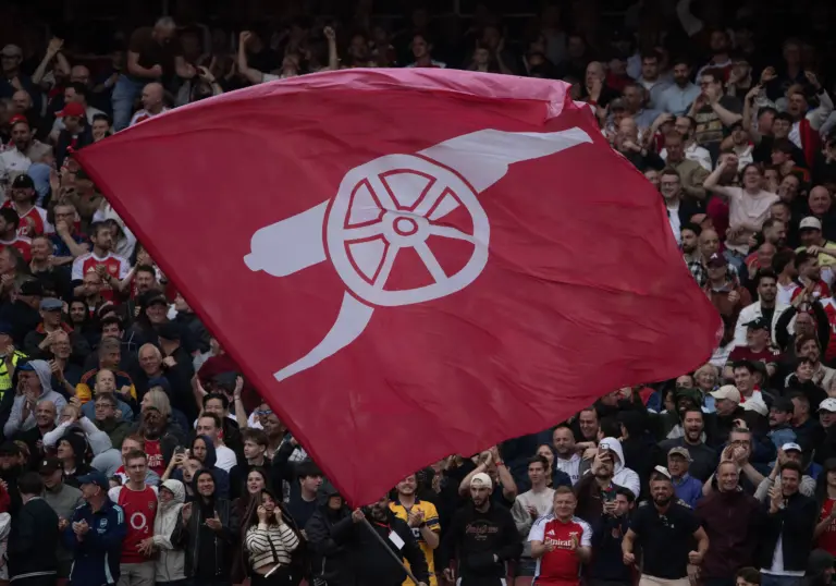 Arsenal fans holding giant fan flag at the Emirates