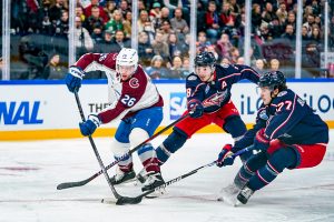 Jacob MacDonald of Colarado (L) against Zach Werenski of Columbus (C) and Nick Blankenburg of Columbus (R) during the 2022 NHL Global Series - Finland match between Colorado Avalanche and Columbus Blue Jackets at Nokia Arena on November 5, 2022 in Tampere, Finland.