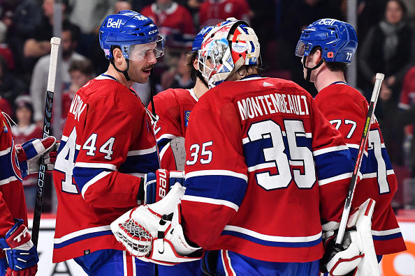 MONTREAL, CANADA - NOVEMBER 09: Joel Edmundson #44 of the Montreal Canadiens and goaltender Sam Montembeault #35 celebrate their victory against the Vancouver Canucks at Centre Bell on November 9, 2022 in Montreal, Quebec, Canada. The Montreal Canadiens defeated the Vancouver Canucks 5-2. (Photo by Minas Panagiotakis/Getty Images)