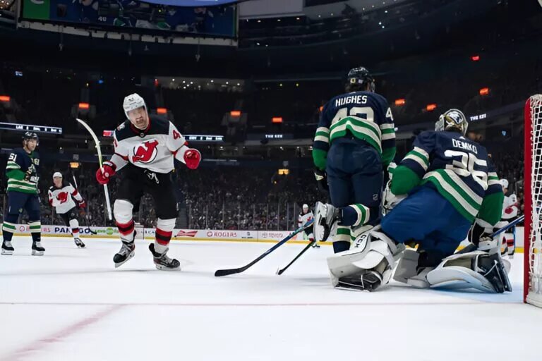 Miles Wood #44 of the New Jersey Devils celebrates after a goal by Michael McLeod #20 (not pictured) of the New Jersey Devils on Thatcher Demko #35 of the Vancouver Canucks of their NHL game at Rogers Arena on November 1, 2022 in Vancouver, British Columbia, Canada.