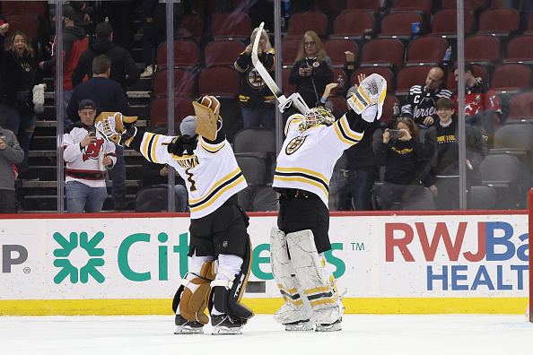 NEWARK, NJ - DECEMBER 28: Boston Bruins goaltender Jeremy Swayman (1) celebrates with Boston Bruins goaltender Linus Ullmark (35) after winning the National Hockey League game between the Boston Bruins and the New Jersey Devils on December 28, 2022 at Prudential Center in Newark, NJ. (Photo by Andrew Mordzynski/Icon Sportswire via Getty Images)