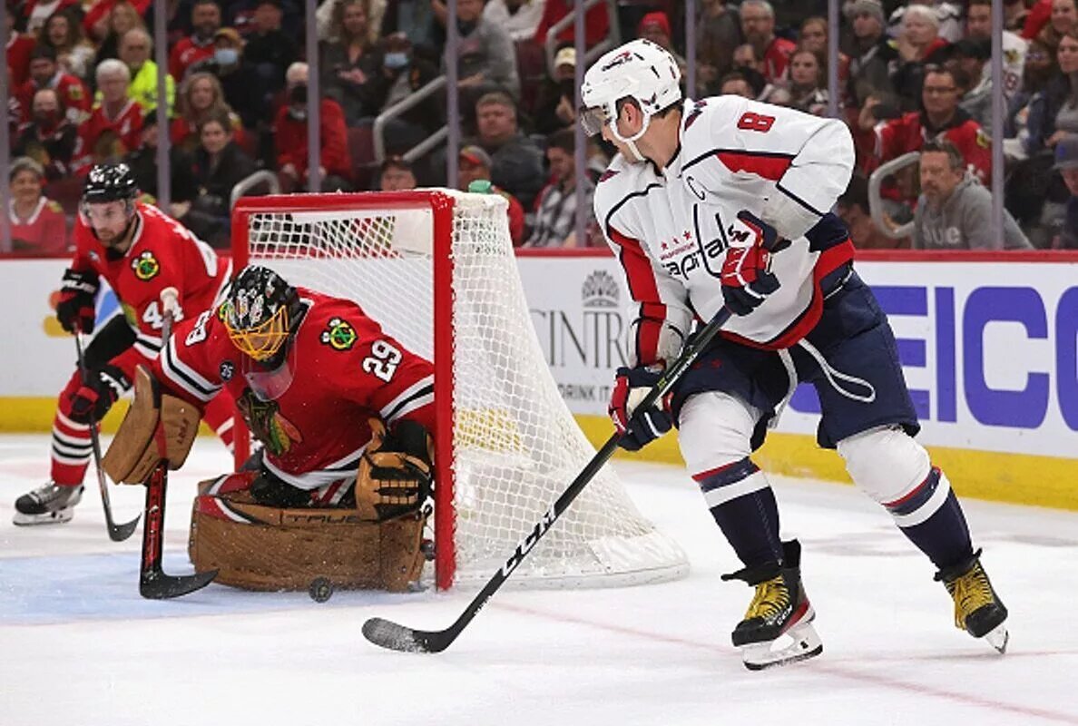 CHICAGO, ILLINOIS - DECEMBER 15: Alex Ovechkin #8 of the Washington Capitals shoots against Marc-Andre Fleury #29 of the Chicago Blackhawks at the United Center on December 15, 2021 in Chicago, Illinois. The Blackhawks defeated the Capitals 5-4 in overtime. (Photo by Jonathan Daniel/NHL/Getty Images)