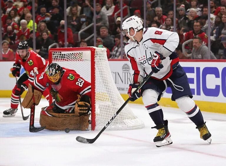 CHICAGO, ILLINOIS - DECEMBER 15: Alex Ovechkin #8 of the Washington Capitals shoots against Marc-Andre Fleury #29 of the Chicago Blackhawks at the United Center on December 15, 2021 in Chicago, Illinois. The Blackhawks defeated the Capitals 5-4 in overtime. (Photo by Jonathan Daniel/NHL/Getty Images)