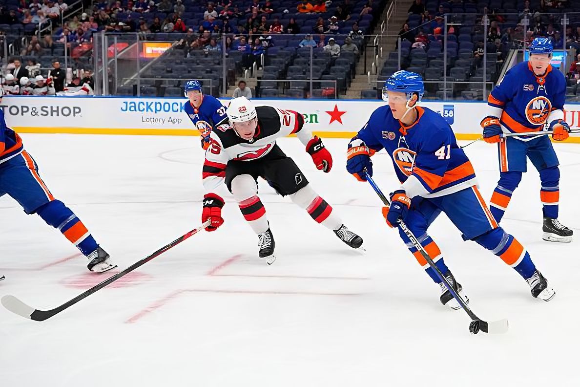 ELMONT, NY - OCTOBER 06: New York Islanders Right Wing Nikita Soshnikov (41) skates with the puck with New Jersey Devils Forward Nolan Foote (25) defending during the second period of the National Hockey League game between the New Jersey Devils and New York Islanders on October 6, 2022, at UBS Arena in Elmont, NY. (Photo by Gregory Fisher/Icon Sportswire via NHL/Getty Images)