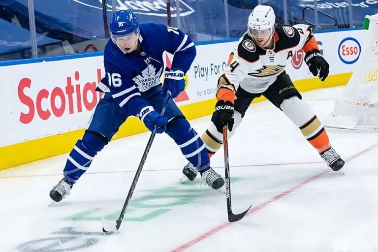 TORONTO, ON - JANUARY 26: Anaheim Ducks Defenceman Cam Fowler (4) defends Toronto Maple Leafs Right Wing Mitchell Marner (16) during the NHL regular season game between the Anaheim Ducks and the Toronto Maple Leafs on January 26, 2022, at Scotiabank Arena in Toronto, ON, Canada. (Photo by Julian Avram/Icon Sportswire via NHL/Getty Images)
