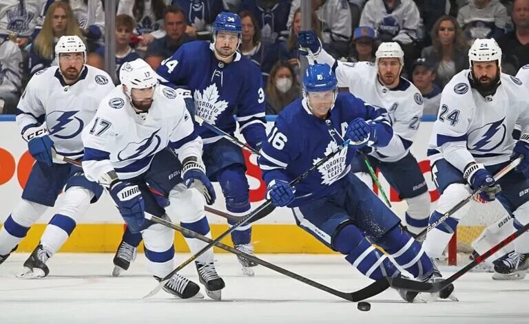 TORONTO, ON - MAY 14: Alex Killorn #17 of the Tampa Bay Lightning tries to grab a puck against Mitchell Marner #16 of the Toronto Maple Leafs during Game Seven of the First Round of the 2022 Stanley Cup Playoffs at Scotiabank Arena on May 14, 2022 in Toronto, Ontario, Canada. (Photo by Claus Andersen/NHL/Getty images)