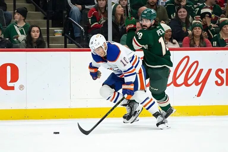 SAINT PAUL, MN - DECEMBER 01: Edmonton Oilers center Derek Ryan (10) skates with the puck while being defended by Minnesota Wild center Nic Petan (19) during the NHL game between the Edmonton Oilers and the Minnesota Wild, on December 1st, 2022, at Xcel Energy Center in Saint Paul, MN. (Photo by Bailey Hillesheim/Icon Sportswire via NHL/Getty Images)
