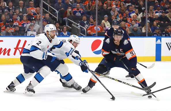 EDMONTON, CANADA - DECEMBER 31: Connor McDavid #97 of the Edmonton Oilers skates with the puck in the third period against the Winnipeg Jets on December 31, 2022 at Rogers Place in Edmonton, Alberta, Canada. (Photo by Lawrence Scott/Getty Images)
