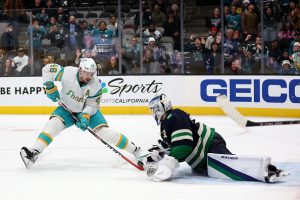 SAN JOSE, CALIFORNIA - DECEMBER 07: Spencer Martin #30 of the Vancouver Canucks makes a save on a shot taken by Tomas Hertl #48 of the San Jose Sharks in overtime at SAP Center on December 07, 2022 in San Jose, California. (Photo by Ezra Shaw/Getty Images)