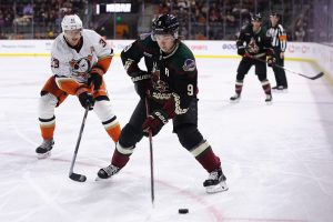 TEMPE, ARIZONA - JANUARY 24: Clayton Keller #9 of the Arizona Coyotes skates with the puck ahead of Jakob Silfverberg #33 of the Anaheim Ducks during the second period of the NHL game at Mullett Arena on January 24, 2023 in Tempe, Arizona. (Photo by Christian Petersen/Getty Images)