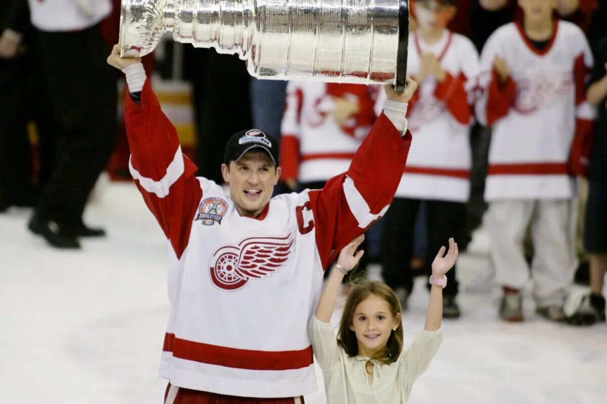 Steve Yzerman winning the NHL Stanley Cup 3 times as a player for the Red Wings
