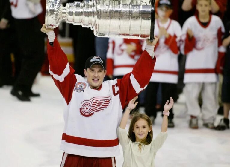 Steve Yzerman winning the NHL Stanley Cup 3 times as a player for the Red Wings