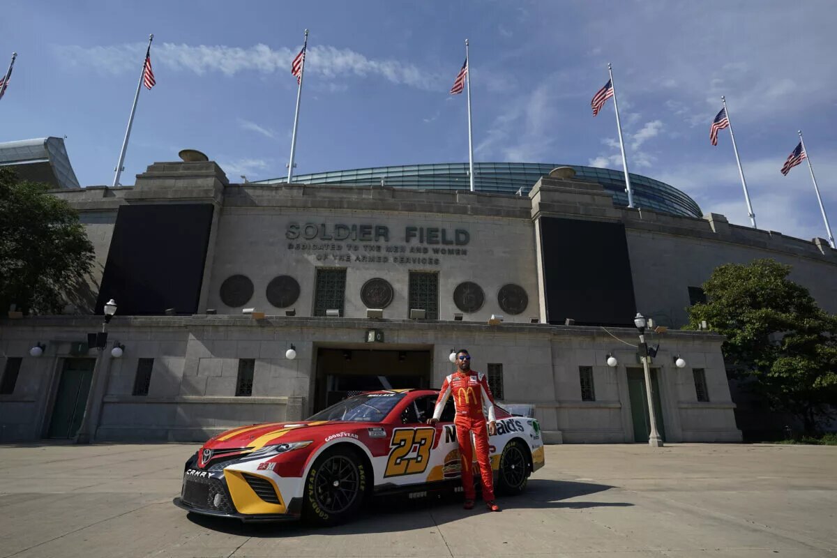 NASCAR schedule - Bubba Wallace stands in front of his #23 Toyota in Chicago