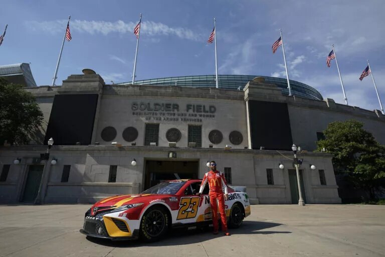 NASCAR schedule - Bubba Wallace stands in front of his #23 Toyota in Chicago