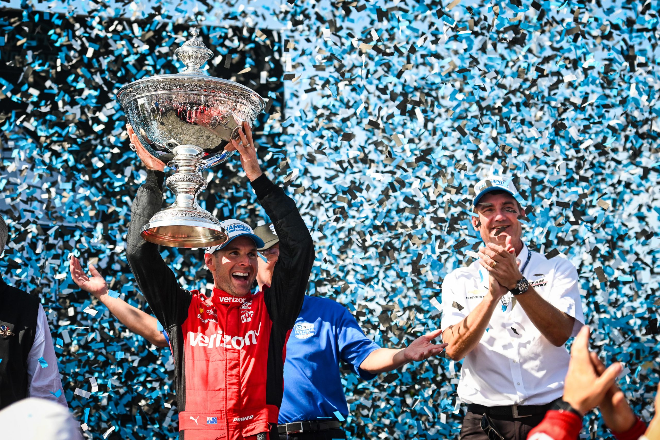 Team Penske's Will Power lifts the Astor Challenge Cup after clinching the IndyCar Series championship at Laguna Seca