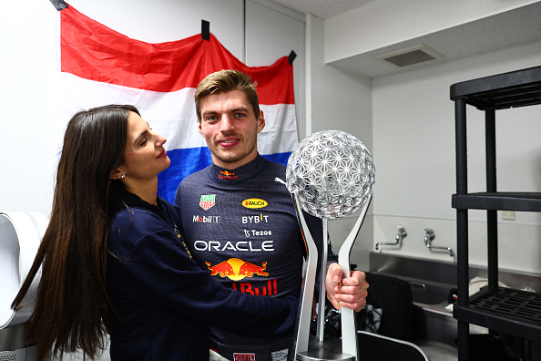 SUZUKA, JAPAN - OCTOBER 09: Race winner and 2022 F1 World Drivers Champion Max Verstappen of Netherlands and Oracle Red Bull Racing celebrates with Kelly Piquet and his trophy after the F1 Grand Prix of Japan at Suzuka International Racing Course on October 09, 2022 in Suzuka, Japan. (Photo by Mark Thompson/Getty Images )