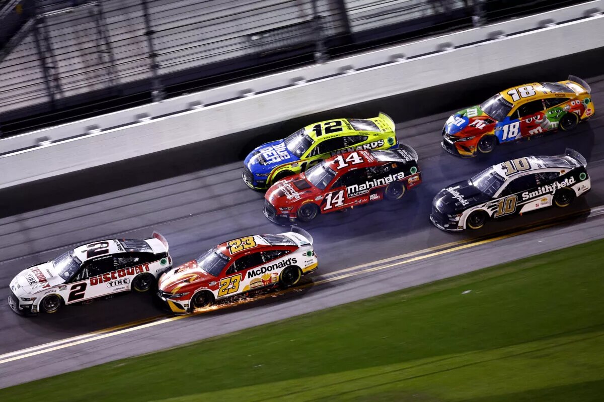 DAYTONA BEACH, FLORIDA - FEBRUARY 20: Austin Cindric, driver of the #2 Discount Tire Ford, and Bubba Wallace, driver of the #23 McDonald's Toyota, race to the finish of the NASCAR Cup Series 64th Annual Daytona 500 at Daytona International Speedway on February 20, 2022 in Daytona Beach, Florida. (Photo by Jared C. Tilton/Getty Images)